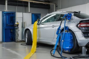 Classic car undergoing full paint restoration showing before and after transformation